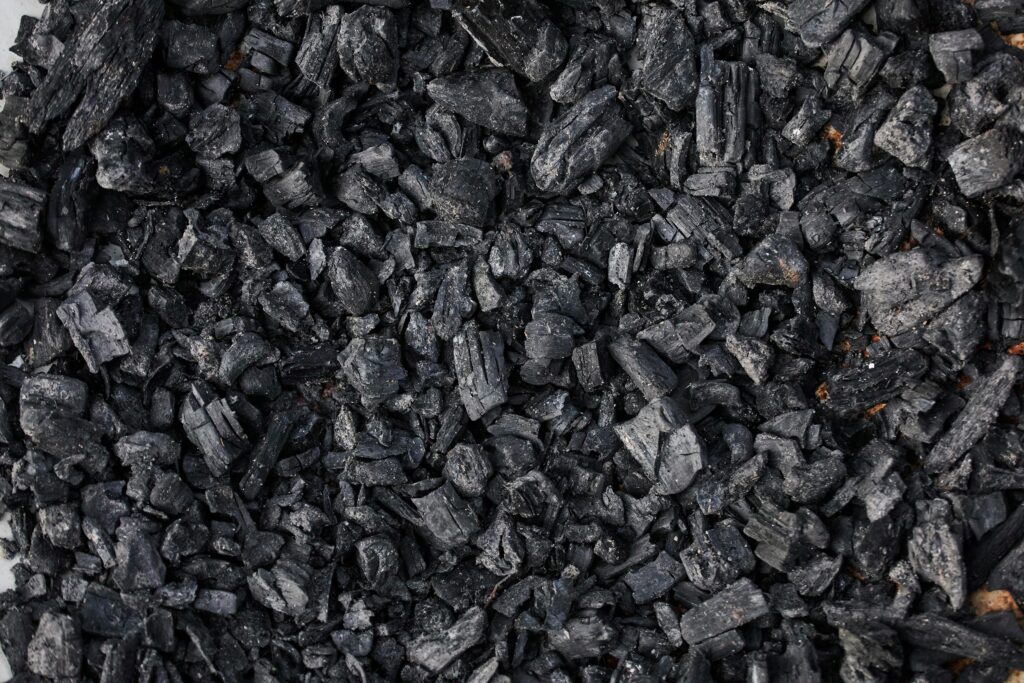High-resolution image showing a detailed view of charcoal pieces, ideal for fuel or artistic use.